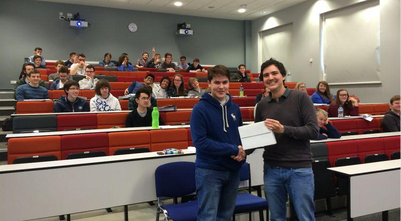 QUB Student accepting AquaQ Giveaway Prize